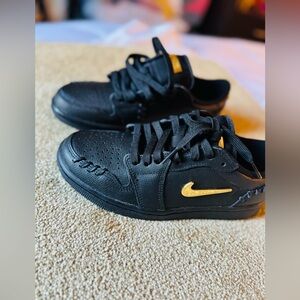 Nike Black Sneakers with Gold Swoosh